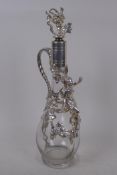 A clear glass and silver plate claret decanter decorated with vine leaves and a female