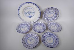 Seven Italian Majolica plates with shaped rims and putti decoration, largest 32cm diameter