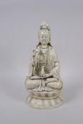 A Chinese blanc de chine porcelain figure of Quan Yin seated on a lotus throne, impressed seal marks