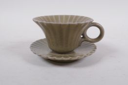 A Chinese celadon glazed porcelain Song style tea cup and saucer of petal form, 6cm high