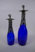 Two blue glass decanters with silver plated vine leaf decoration and stopper, largest 35cm high