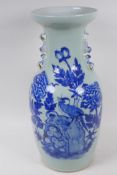 A Chinese blue and white porcelain vase decorated with a bird on a rock, with handles in the form of