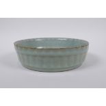 A Chinese Ru ware style celadon glazed steep sided dish with frilled rim, 18cm diameter