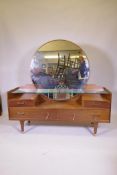 A 1960s E. Gomme G-Plan Mainstream dressing table with large circular mirror, model 1910L, 153cm x
