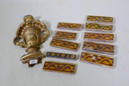 An antique giltwood mount, 36cm long, and a quantity of wall tiles
