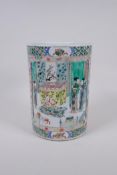 A famille verte porcelain brush pot with decorative panels depicting figures in temple compounds,