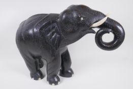 A carved wood African elephant with bone tusks, 34cm high