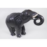 A carved wood African elephant with bone tusks, 34cm high