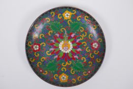 A Chinese cloisonne dish with lotus flower decoration, the base decorated with bats and auspicious