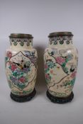 A pair of Japanese Satsuma pottery oil lamp base vases, painted with birds and flowers on carved