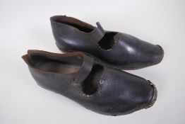 A pair of antique leather and wood dancing clogs, 26cm long