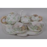 A Belleek style Shamrock pattern china cabaret set with green harp and crown back stamp, sucrier AF,