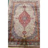 An ivory ground Kashmir carpet with central floral medallion design, 240 x 156cm