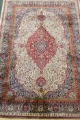 An ivory ground Kashmir carpet with central floral medallion design, 240 x 156cm
