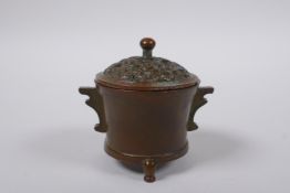 A Chinese bronze censer and cover on tripod supports with two handles, 4 character mark to base, 7cm