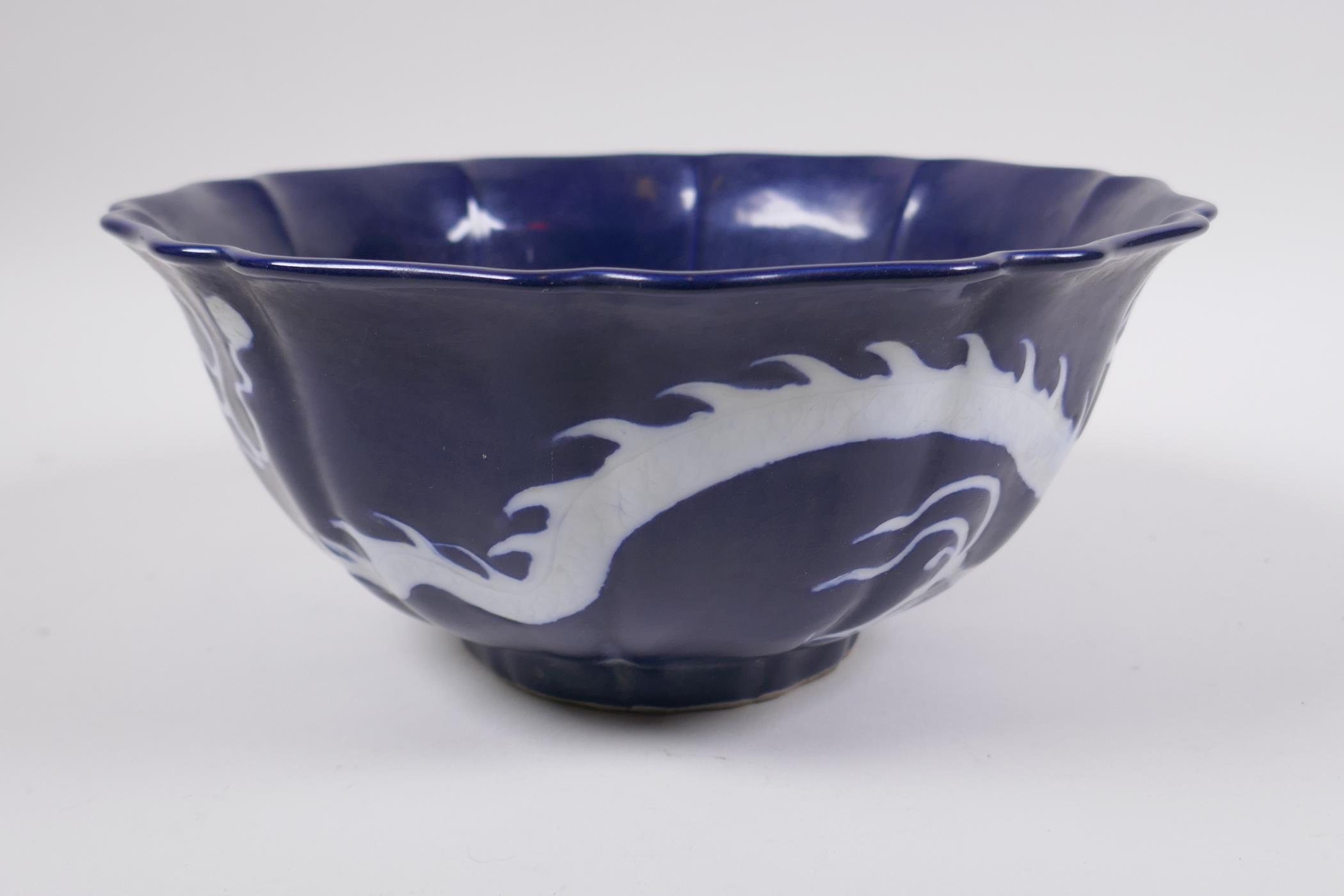 A Chinese blue and white porcelain steep sided bowl with lobed rim, decorated with a white dragon - Image 3 of 6