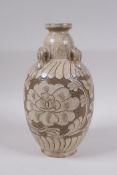 A Chinese Cizhou kiln vase with four loop handles and chased floral decoration, 23cm high