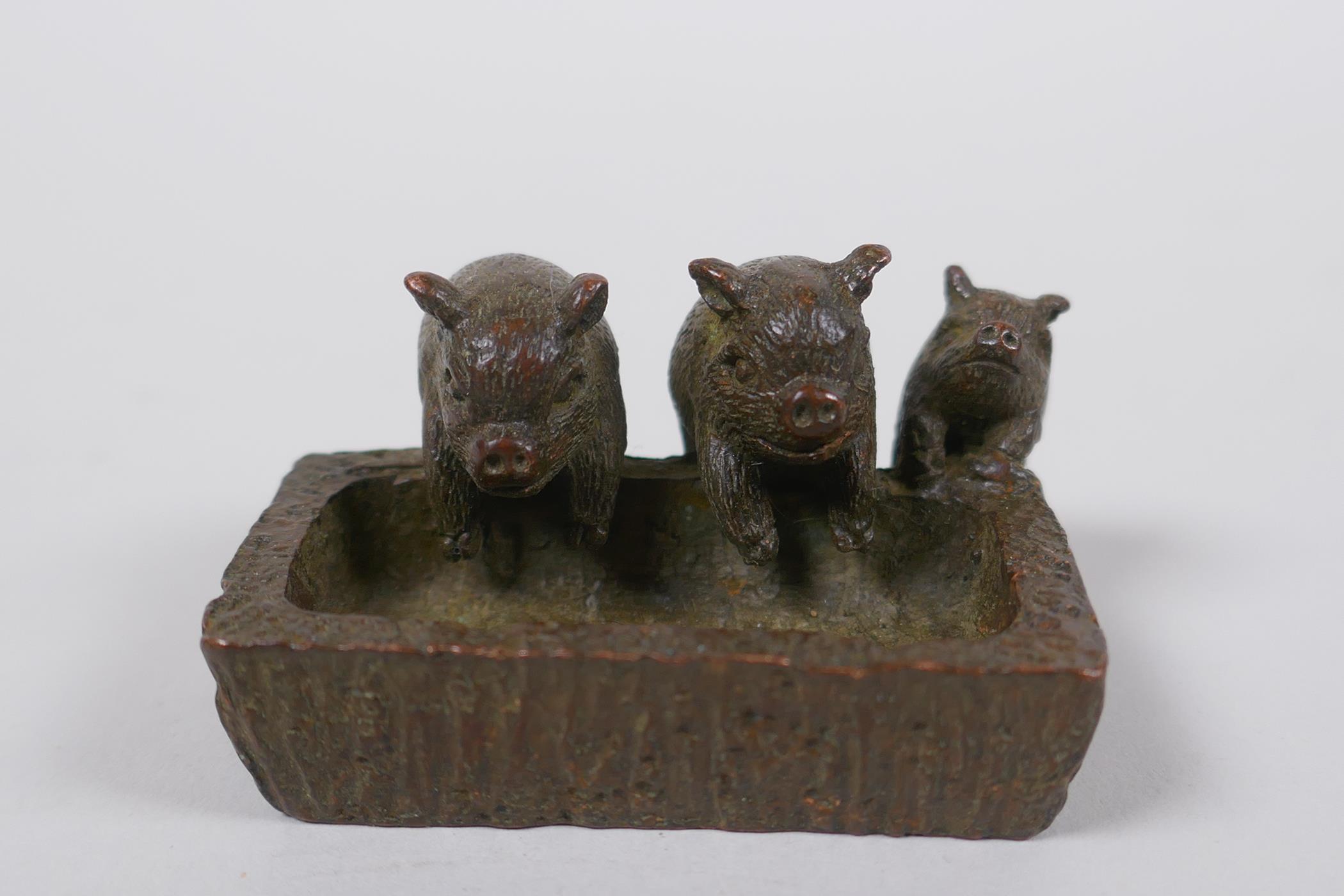 A miniature oriental bronze figure group of pigs at a trough, 5cm long - Image 2 of 4