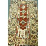 A Persian full pile multicolour ground wool carpet, the central panel with floral medallions on a