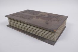 A Chinese wood and fabric bound book containing white jade tablets with chased and gilt character