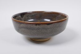 A Chinese Cizhou kiln bowl with treacle speckled glaze, indistinct impressed seal mark to base, 15cm