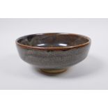 A Chinese Cizhou kiln bowl with treacle speckled glaze, indistinct impressed seal mark to base, 15cm