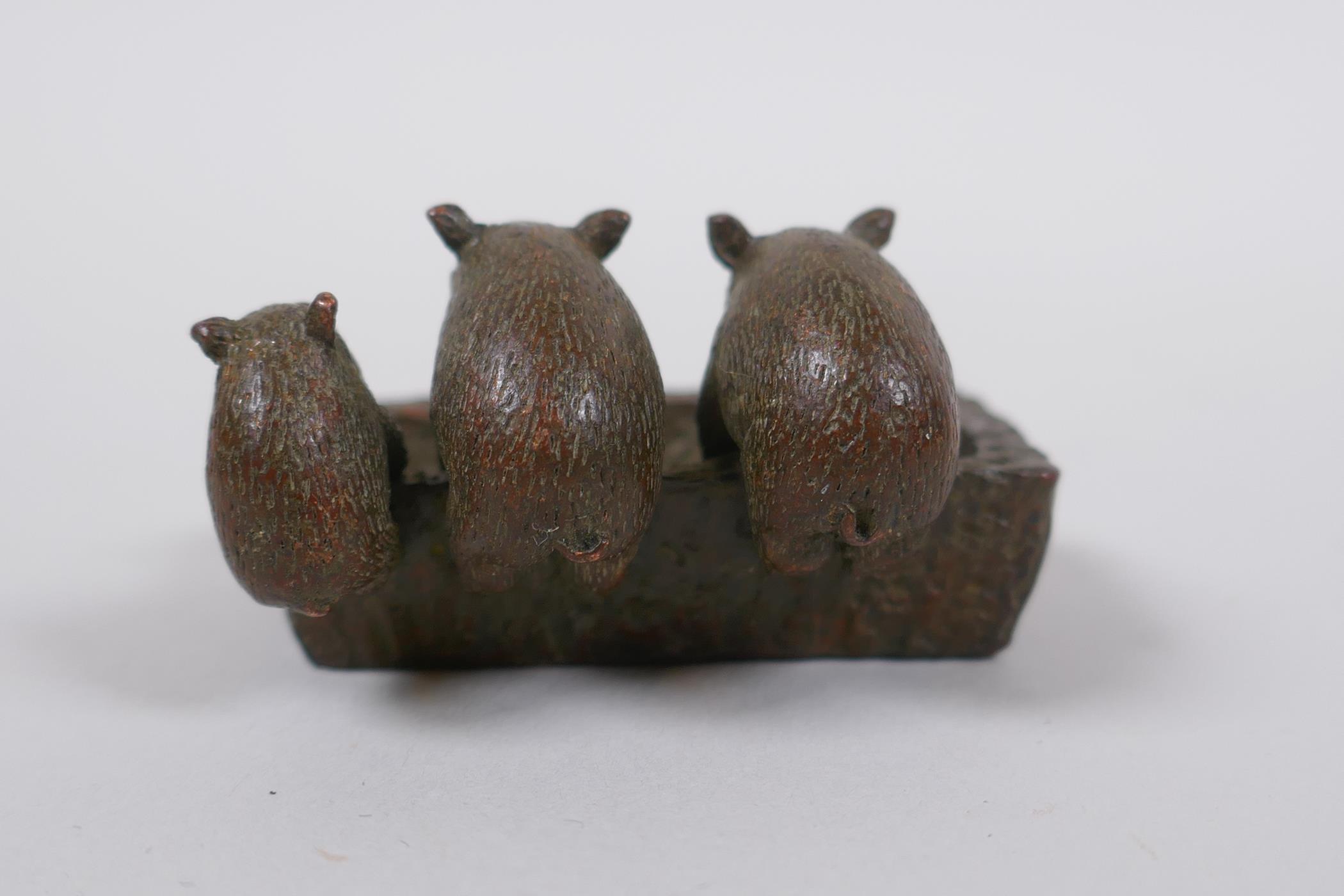 A miniature oriental bronze figure group of pigs at a trough, 5cm long - Image 3 of 4