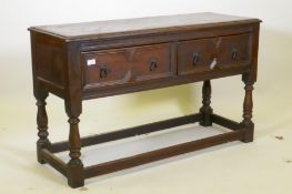 A Jacobean style two drawer buffet, raised on baluster turned supports, 122 x 46cm, 74cm high
