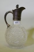 A Victorian cut glass and silver mounted claret jug with engraved floral decoration and Latin