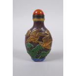 A Peking glass snuff bottle with carved, enamelled and gilt bird decoration, 8cm high