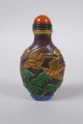 A Peking glass snuff bottle with carved, enamelled and gilt bird decoration, 8cm high