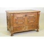 A C19th Continental painted pine mule chest, the lift up top revealing a candle box, the front and