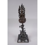 A Sino Tibetan gilt bronze figure of Buddha seated within a lotus flower, 32cm high