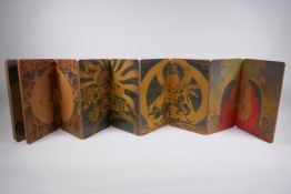 A Sino Tibetan printed concertina book depicting scenes from thangkas, 17 x 28cm
