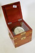 A Russian Kirova marine chromometer, gimballed in the dial numbered 595, brass mounted wood case,