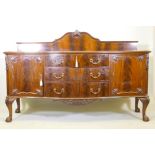 A mahogany Chippendale style serpentine front sideboard, with carved decoration and canted