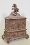 A Black Forest carved wood jewellery chest, 39cm high