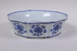 A blue and white porcelain steep sided dish with lobed rim and lotus flower bouquet decoration,