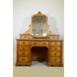 A Victorian inlaid oak kneehole dressing table, the upper with swing mirror flanked by two drawers