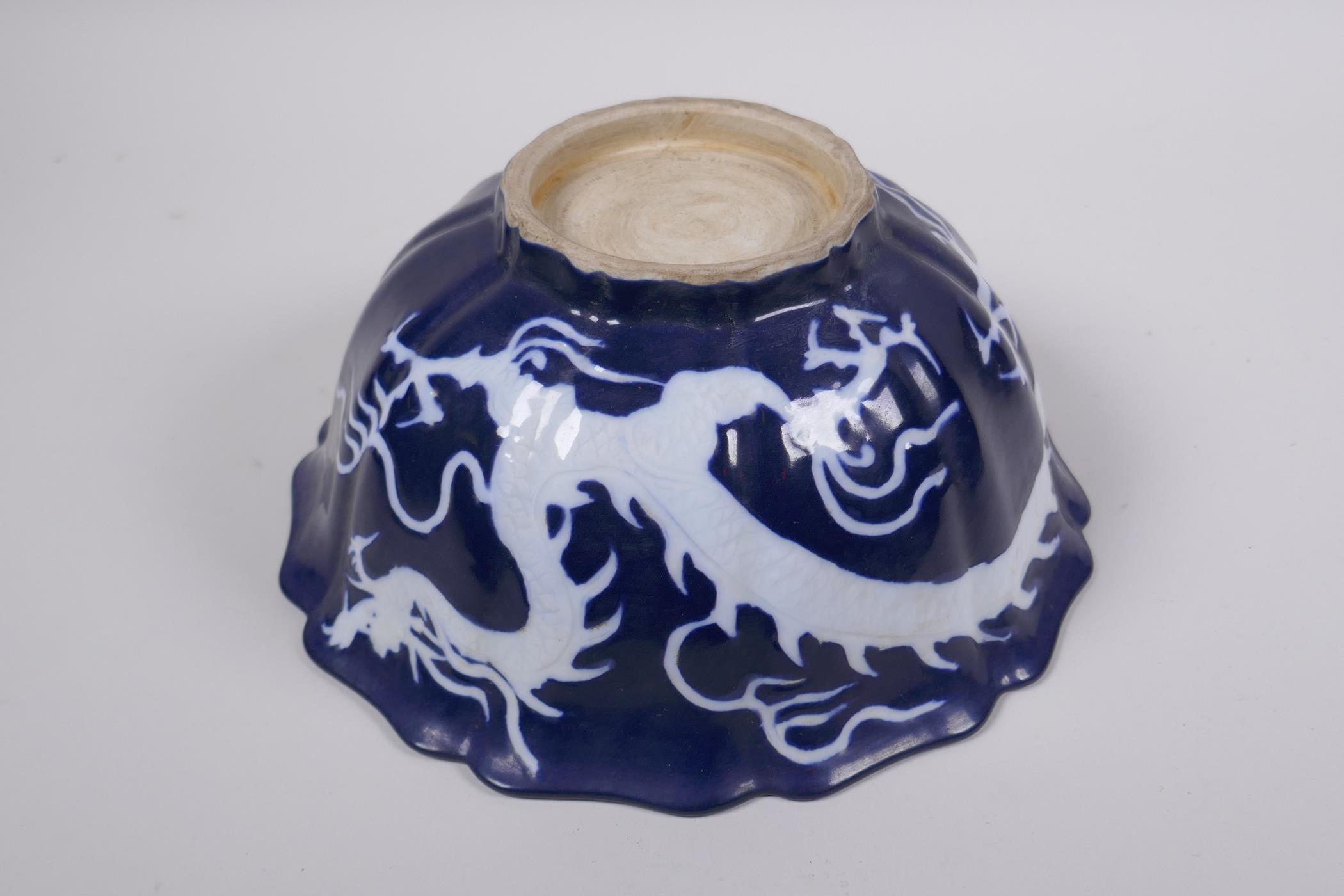 A Chinese blue and white porcelain steep sided bowl with lobed rim, decorated with a white dragon - Image 5 of 6