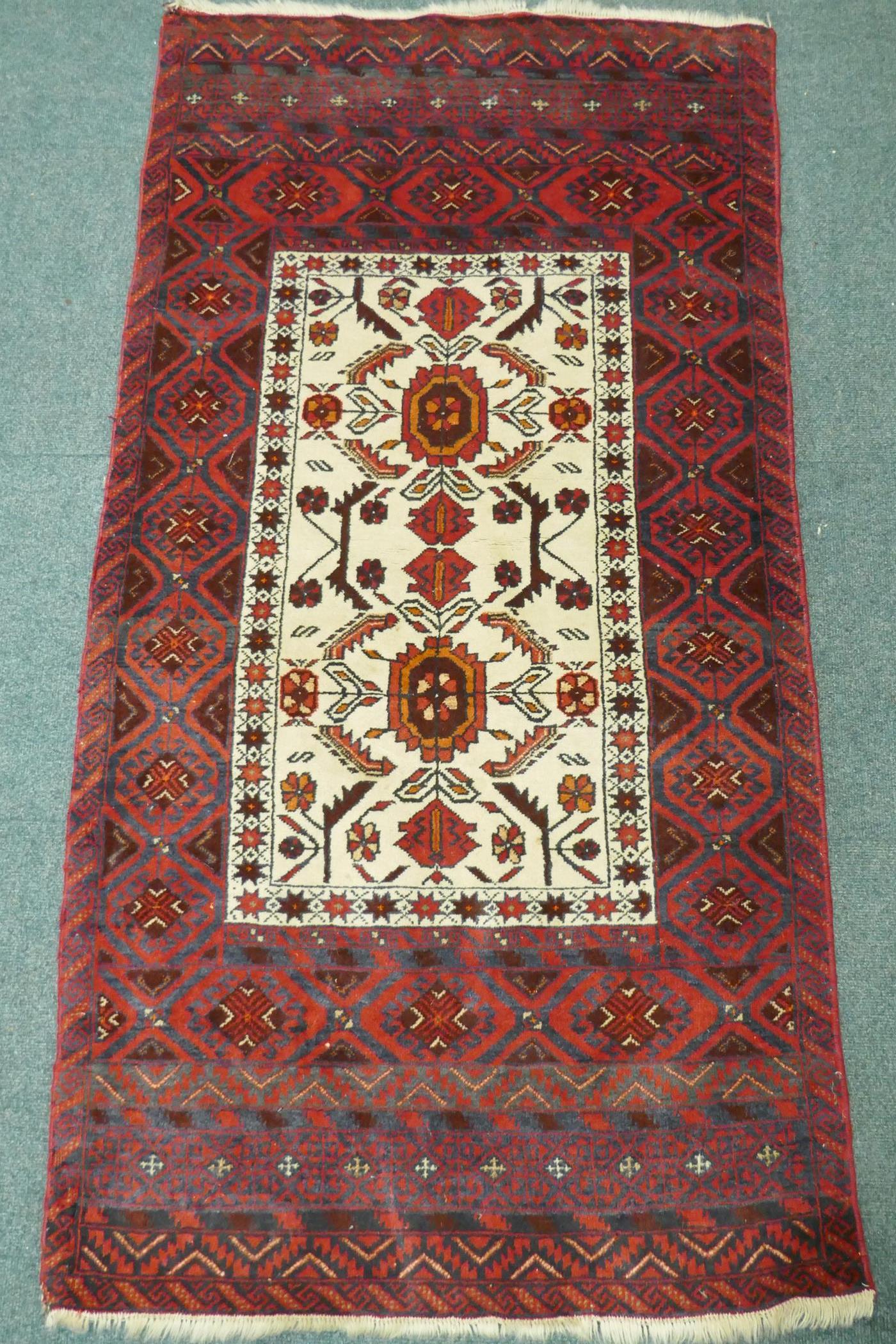 A Middle Eastern hand woven rug with red borders and central panel, with geometric floral designs - Image 2 of 3