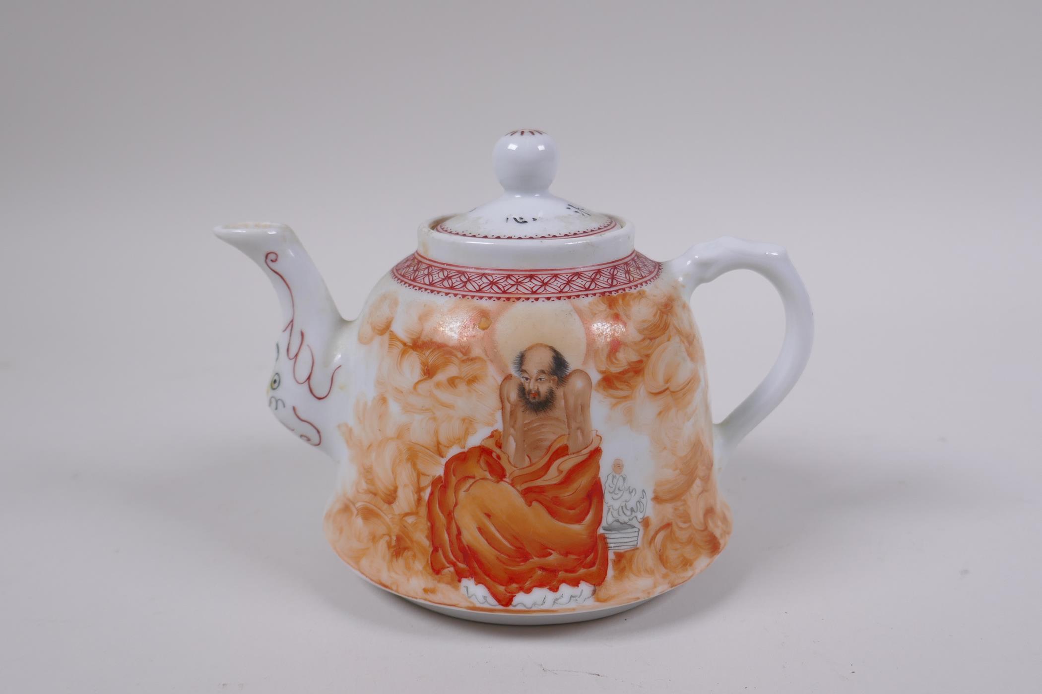 A Chinese Republic period porcelain tea pot decorated with Lohan in iron red robes, inscription
