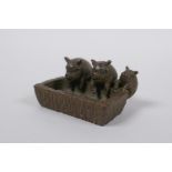 A miniature oriental bronze figure group of pigs at a trough, 5cm long