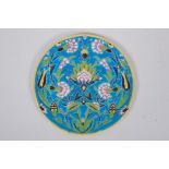 A French Iznik style faience plate with enamelled floral decoration, 21cm diameter