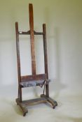 Antique pine artist's easel, with winder adjustment (lacks top bracket), raised on cast iron