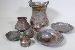 A collection of Eastern tinned copper pots and dishes, and large vessel with repousse decoration