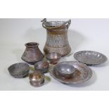 A collection of Eastern tinned copper pots and dishes, and large vessel with repousse decoration