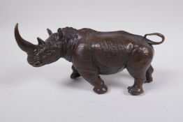 A filled bronze figure of a rhino, 22cm long