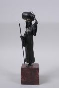 A cold painted bronze figure of a female watercarrier, in the manner of Bergman, 19cm high