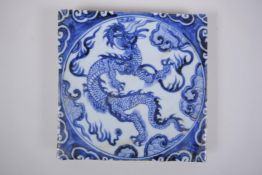 A Chinese blue and white porcelain temple tile with dragon decoration, 20 x 20cm
